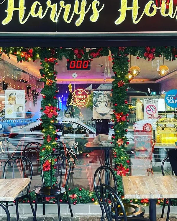 Our shopfront dressed up for Christmas, the team putting up decorations